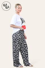 White leopard print plissé trousers side view – Highlighting wide leg design and flowy fit.