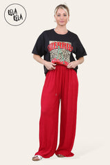 Model in stylish red wide leg trousers with elasticated waistband and chic silhouette