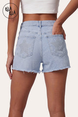 Back view of model wearing RELA RELA Silver Star Diamante Stretchy Denim Shorts, featuring twin back pockets with star diamante embellishments and raw distressed hem.