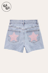 Flat lay back view of RELA RELA Baby Pink Star Diamante Light Wash Denim Shorts, showcasing twin back pockets with statement pink star diamante embellishments and raw distressed hem.