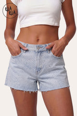 Front view of model wearing RELA RELA Royal Blue Star Diamante Light Wash Denim Shorts, featuring button closure, front pockets with silver-tone hardware, all-over delicate rhinestone embellishment, and raw distressed hem.