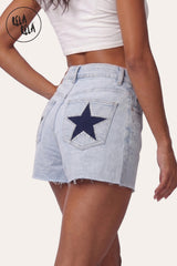 3/4 back-side angle of model wearing RELA RELA Royal Blue Star Diamante Light Wash Denim Shorts, showcasing the side pocket rhinestone detailing and the back star embellishment with the flattering vintage straight-leg silhouette.