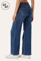 Side view showing the relaxed dad fit and wide leg silhouette of the stretchy mid-waist jeans.