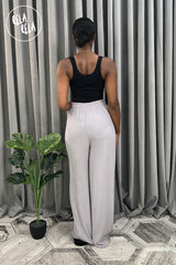 Back view of grey plissé wide leg trousers