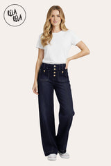 Model wearing in stretchy Wide Leg Seamed Jeans with buttons in rinse blue, styled with a casual top and sneakers.