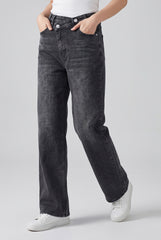 Angled model view of RELA RELA Dark Grey asymmetric waist wide-leg jeans, showing the relaxed straight leg, soft stretch denim and pocket detail.