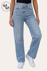 Front view of a model wearing the Rela Rela Blue asymmetric waist wide leg jeans. Highlights the unique cross-front button detail and flattering high-rise sculpting fit.
