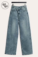 Flat lay of the Vintage Blue asymmetric jeans, featuring the gap-free high-waisted fit and clean pocket detailing on the premium stretch denim.