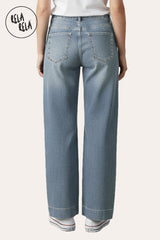 Back view of vintage blue wide leg jeans with studded rivet details and stretchy denim fabric.