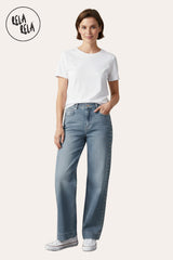 Model Full outfit featuring stretchy studded rivet wide leg jeans in vintage blue, paired with casual top and sneakers.