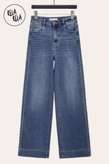 Front view of indigo wide leg jeans with metallic studded rivet accents and stretchy denim fabric