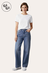 Model in full outfit featuring stretchy studded rivet wide leg jeans in indigo, paired with fitted top and sneakers