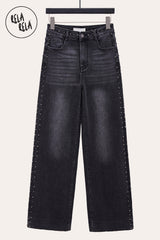 Front view of charcoal wide leg jeans with metallic studded rivet accents and stretchy denim fabric.