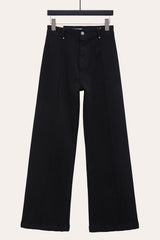  Front view black pintuck flare jeans with front seam laid flat, showcasing seamed wide leg jeans design.