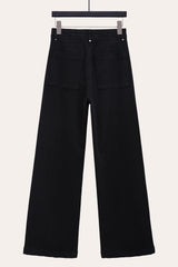 Back view of black front seam flare jeans, highlighting relaxed wide leg silhouette.