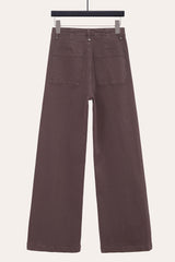 Back view of chocolate front seam flare jeans, highlighting relaxed wide leg silhouette.