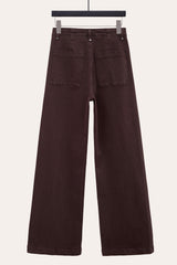 Back view of dark chocolate front seam flare jeans, highlighting relaxed wide leg silhouette.