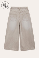 RELA RELA Beige baggy fit longline denim jorts flat lay back view on cream background, showing warm Beige wide-leg denim with two patch back pockets and the below-knee longline hemline