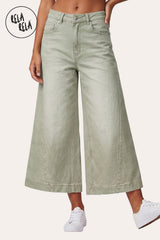 RELA RELA Sage baggy fit longline denim jorts worn on body, cropped view from waist to mid-shin showing the muted Sage green wide-leg denim with silver metal button at the waistband, paired with white sneakers