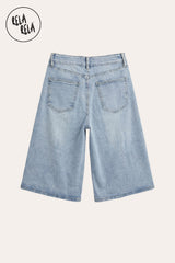 Flat lay of the Back of Light Blue distressed denim jorts, highlighting the strategic rips, raw hems, and authentic vintage-inspired wash.