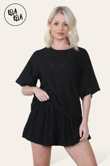 Model wearing black shorts co ord set – crochet texture two piece outfit