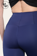 Detail shot of seamless stitching on navy high waisted leggings