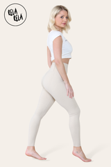 Side angle showing beige sculpting leggings contouring the waist and hips