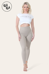 Model stretching in grey high waisted workout leggings, showing flexibility