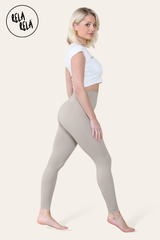 Side angle showing grey sculpting leggings contouring the waist and hips