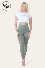 Model stretching in olive green sculpting leggings for gym