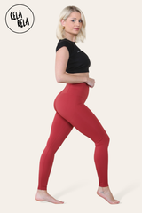 Side profile of high waisted sculpting leggings in wine red colour