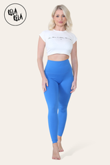 Model stretching in blue high waisted workout leggings, showing flexibility