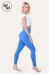 Side angle showing blue sculpting leggings contouring the waist and hips
