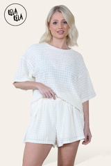 Model wearing cream shorts co ord set – crochet texture two piece outfit