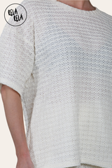 Close-up of crochet fabric on cream T-shirt and shorts co ord set